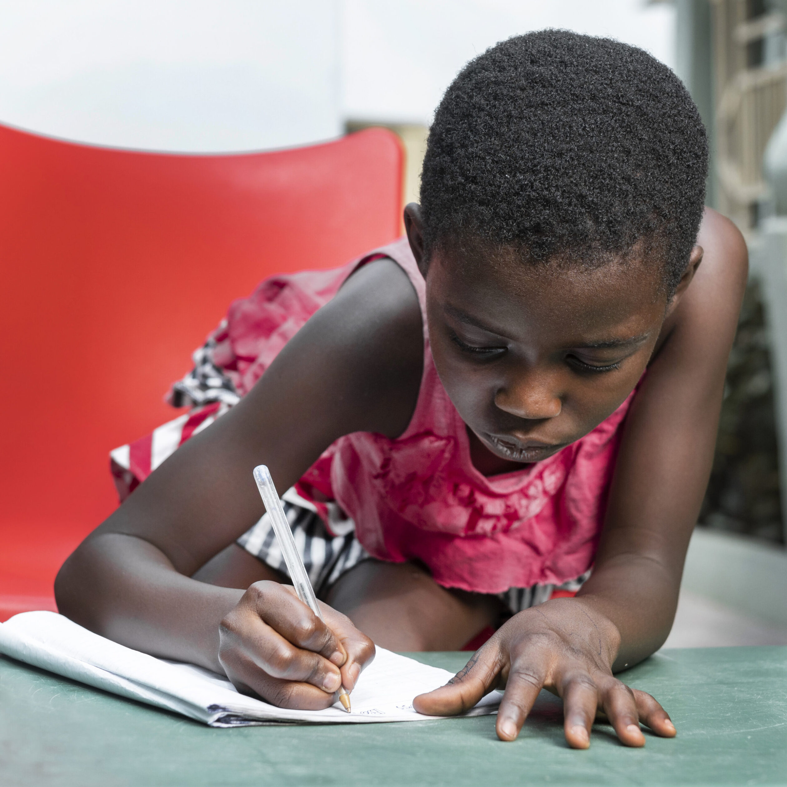 medium shot girl writing notebook